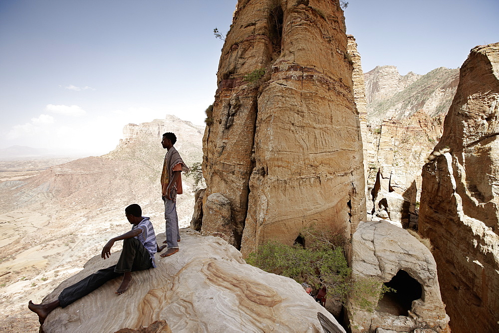 Priest students on a rock, monolithic church Abuna Yemata Guh, Hawzien, Tigray Region, Ethiopia