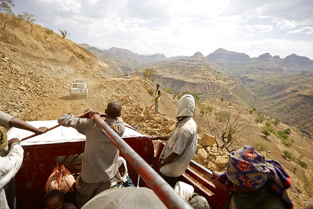 Passengers on the loading area of a truck, road construction zone, near Adi Ar Kay, Amhara region, Ethiopia