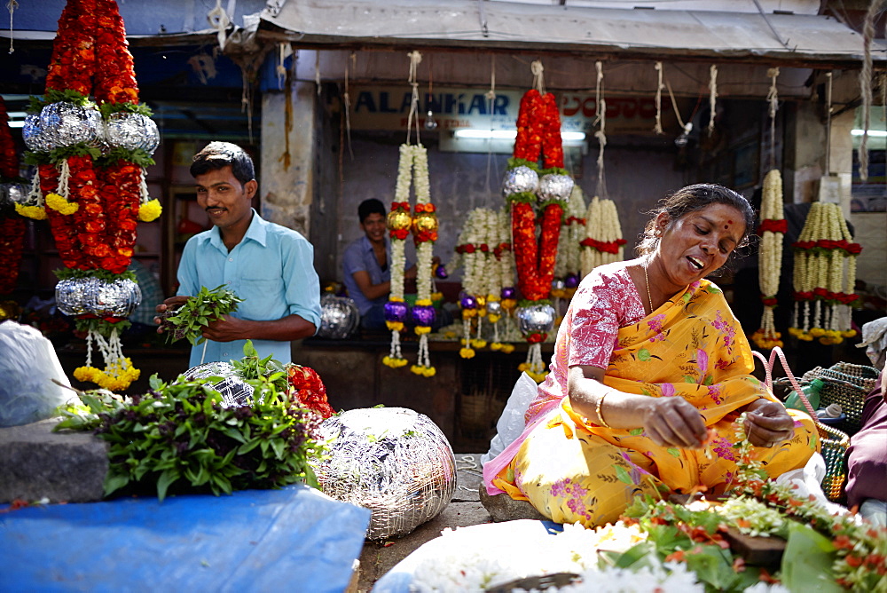 Woman stringing flower garland, Devaraja Market, Mysore, Karnataka, India