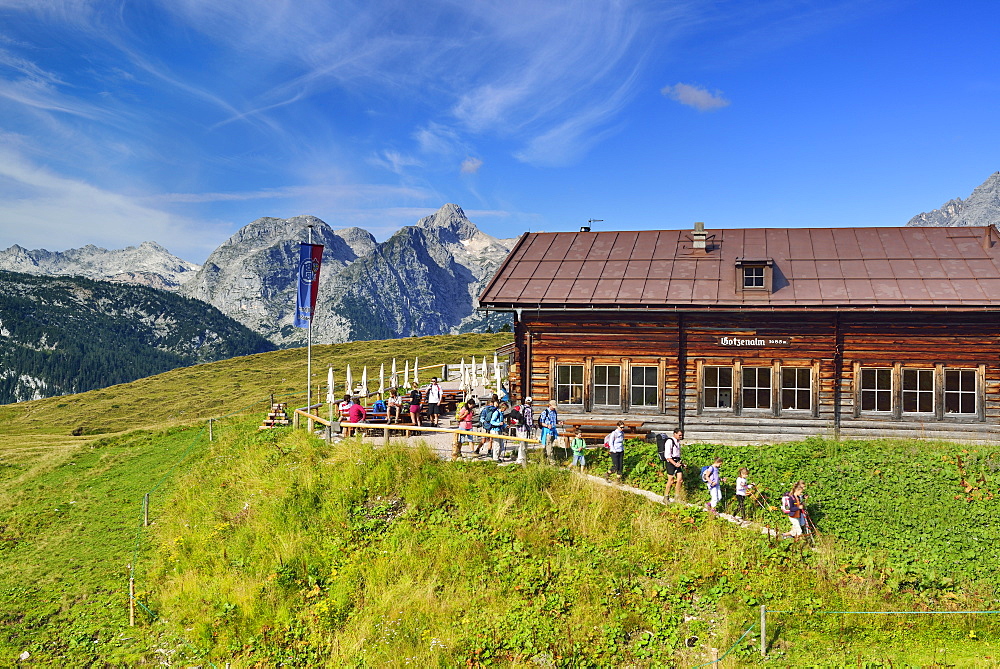 Hikers leaving alpine hut in front of Hundstod, Gotzenalm, Berchtesgaden National Park, Berchtesgaden Alps, Upper Bavaria, Bavaria, Germany