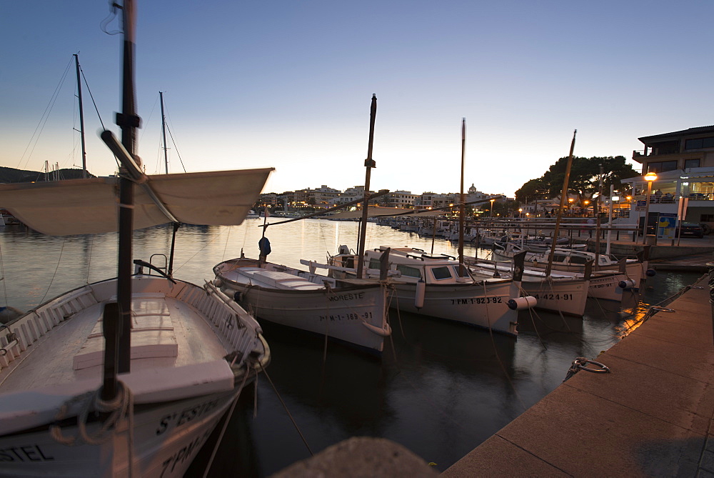 Llauts or Mallorcan fishing boats in the port of Cala Ratjada at the jetty, Cala Ratjada, Mallorca, Balearic Islands, Spain