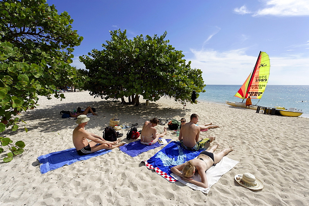 Tourists sunbathing at Playa Ancon, Trinidad, Sancti Spiritus, Cuba, West Indies