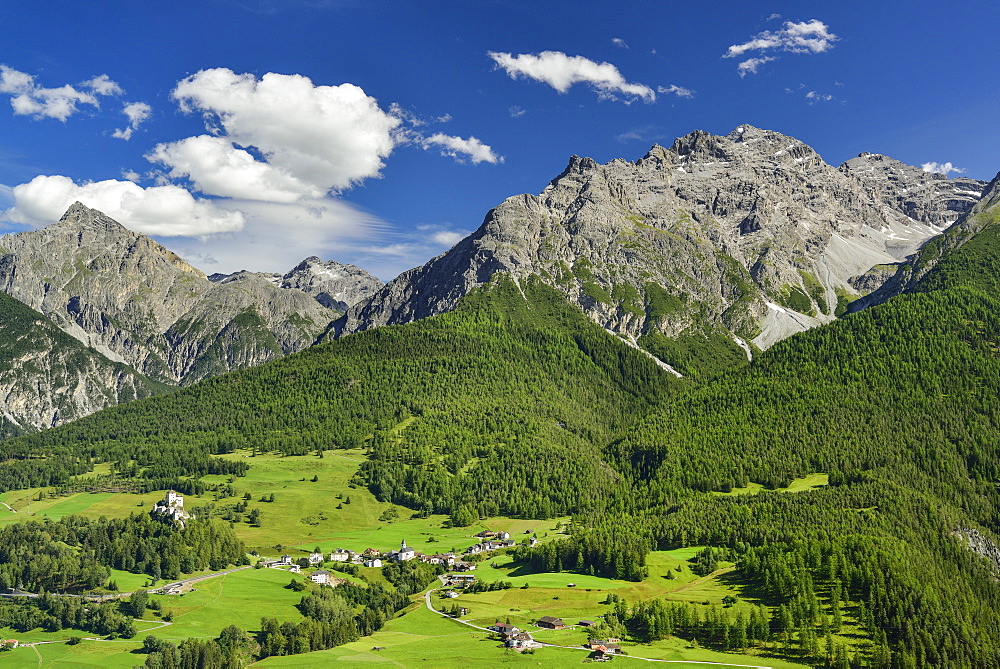 View to castle of Tarasp and Fontana with Sesvenna range in background, Lower Engadin, Canton of Graubuenden, Switzerland