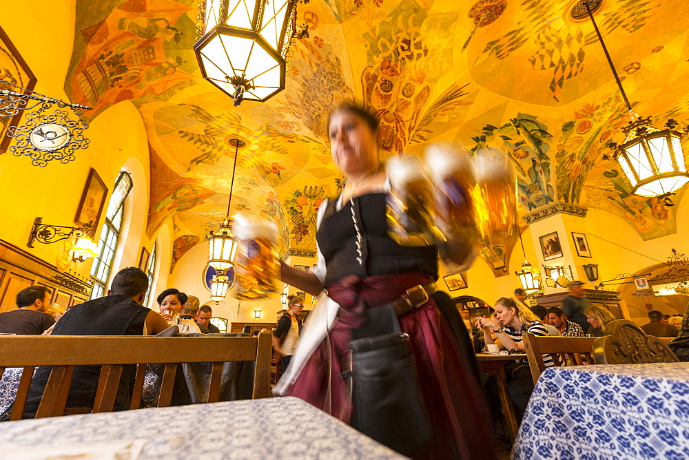 Waitress carrying beer in Hofbraeuhaus, Munich, Upper Bavaria, Bavaria, Germany