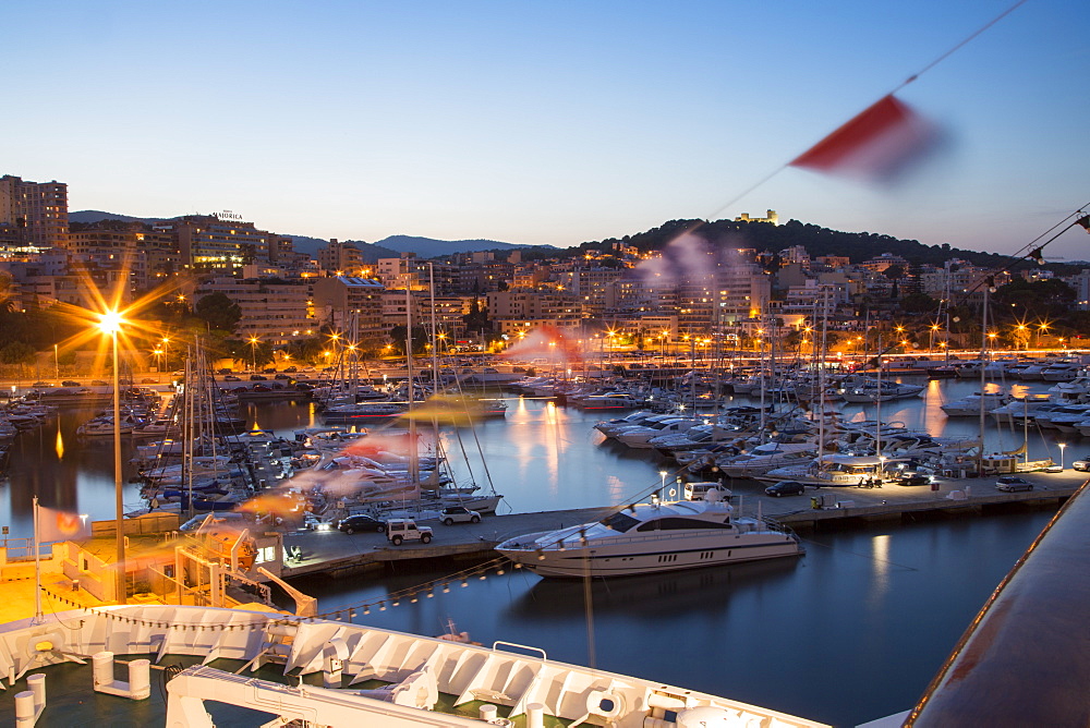 Bow of cruise ship MS Deutschland (Reederei Peter Deilmann) and sailing boats in the marina at dusk, Palma, Mallorca, Balearic I