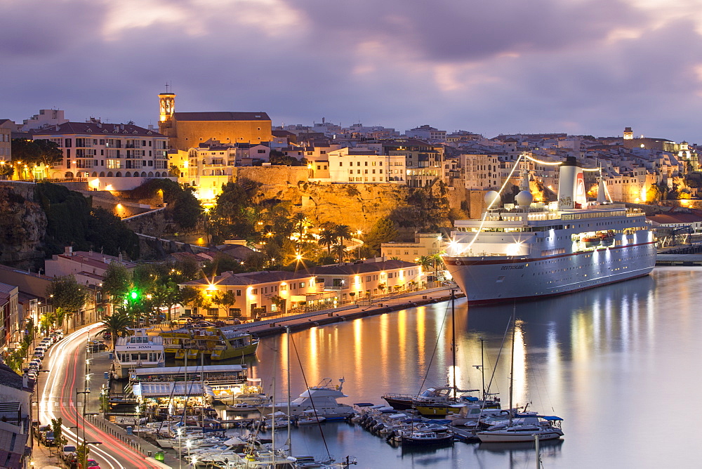 Cruise ship MS Deutschland (Reederei Peter Deilmann) at the pier and old town buildings at dusk, Mahon, Menorca, Balearic Island