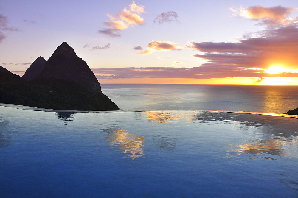 swimming pool of La Haut Plantation hotel at sunset with sea view and volcano mountains The Pitons with Gros and Petit Piton, UNESCO world heritage, Soufriere, St. Lucia, Saint Lucia, Lesser Antilles, West Indies, Windward Islands, Antilles, Caribbean, Central America