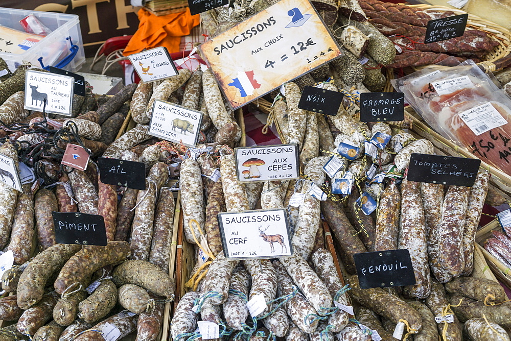 Suassages and salami on the market stall in Lourmarin, Provence-Alpes-Cote d’Azur, France