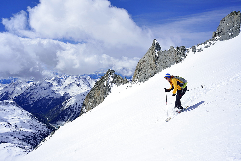 Female back-country skier downhill skiing from Grosser Moeseler, Zillertal Alps, South Tyrol, Italy