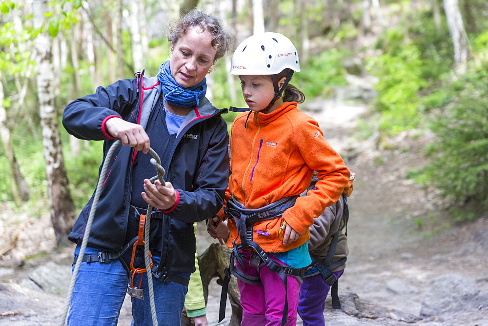 Mother showing daughter how to make a knot, climbing area, Saxony Switzerland, Elbe sandstone mountains, Dresden, Saxony, Germany, Europe