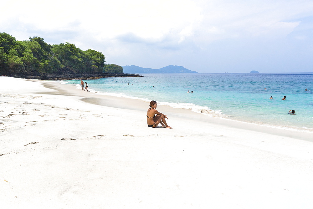 Woman at the white sand beach, Padangbai, Bali, Indonesia