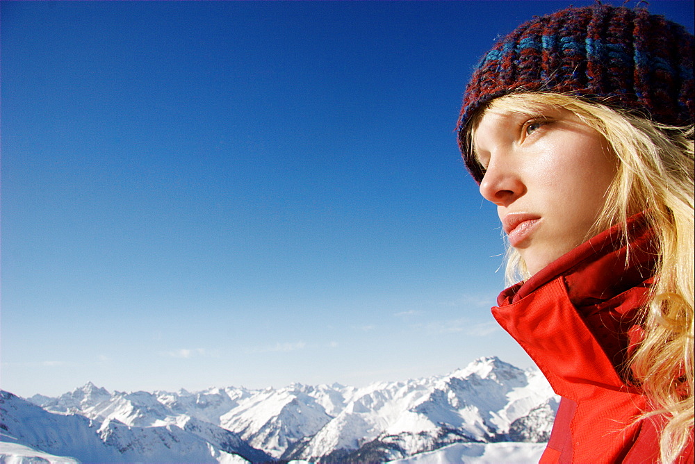 Reflective young woman looking at view, mount Rohnenspitze, Tannheim Valley, Tyrol, Austria