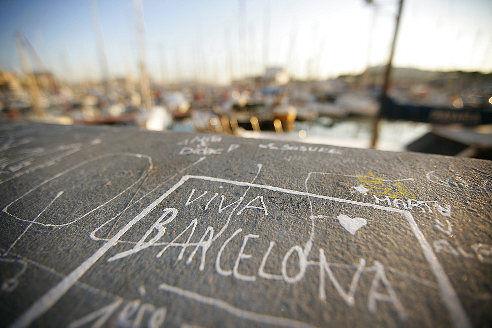 Inscription on the quay wall near the old harbor Port Vell, Barcelona, Katalanien, Spain