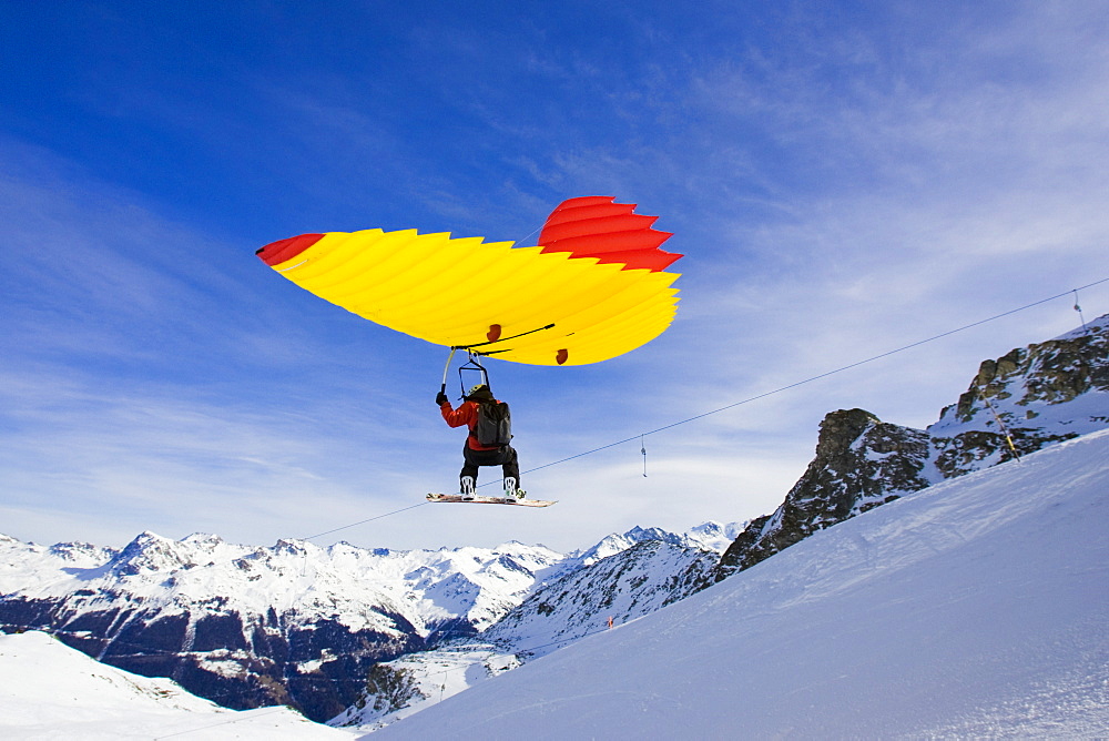 A man with snowboard using a Woopy-Jump, Grimentz, Valais, Switzerland