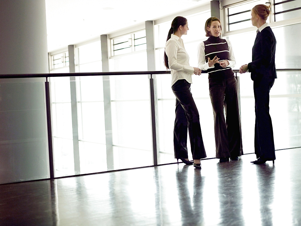 Three businesswomen talking, Munich, Bavaria, Germany