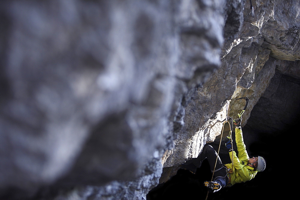 Man climbing in a cave, Immenstadt, Bavaria, Germany