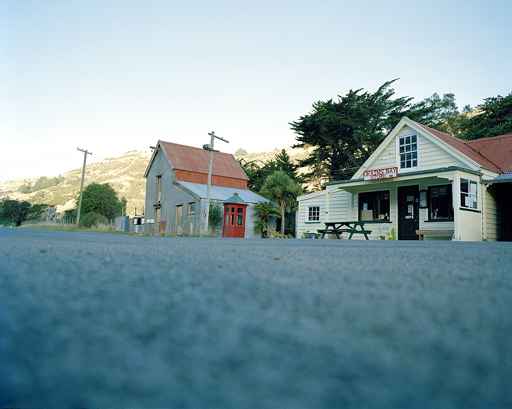 Shop, post office and telephone booth at the main street of the village Okains Bay, Banks Peninsula, South Island, New Zealand