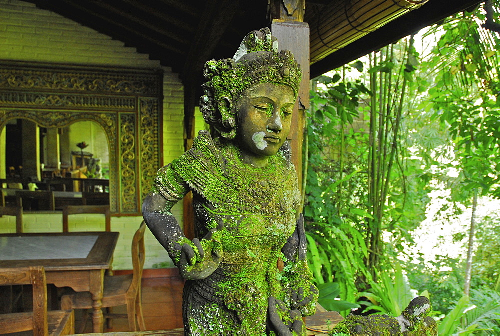 Mossy balinese figure at Murnis Warung, Ubud, Central Bali, Indonesia, Asia