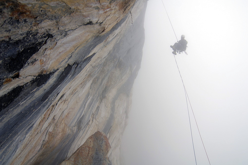 Climber roping in the fog, Tyrol, Austria, Europe