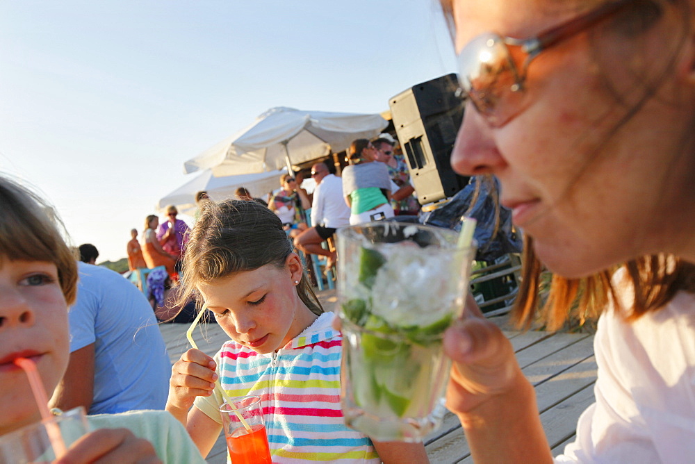 Mother with children in the Pirata Bus beach bar, Formentera, Balearic Islands, Spain