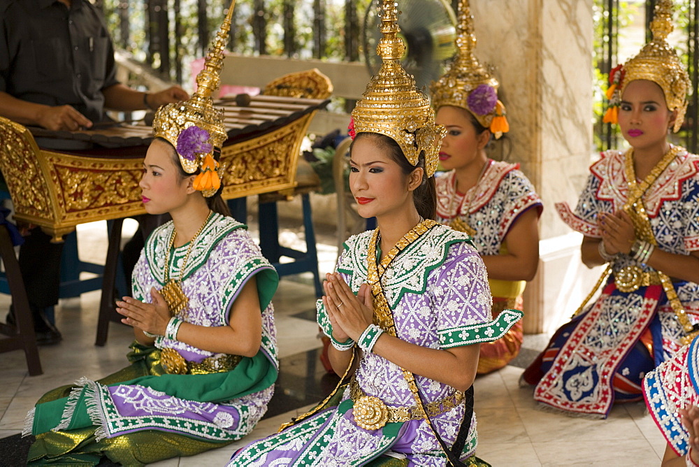 Traditional Thai dancers performing for Brahma, they dancing on request for donations, Erawan Shrine, Ratchadamri Road near Siam Square, Pathum Wan District, Bangkok, Thailand