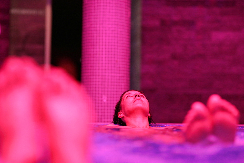 Woman lying in whirlpool, Hotel Krallerhof, Leogang, Salzburger Land, Austria