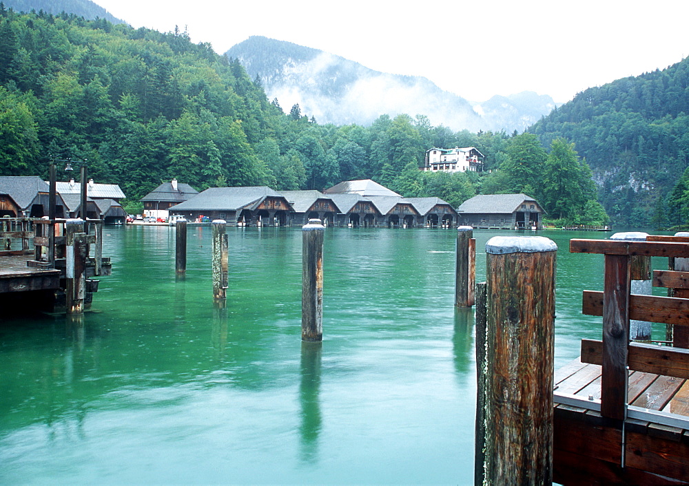 View of Koenigssee with wooden houses and mountains in background, Berchtesgaden National Park, Schoenau, Bavaria, Germany