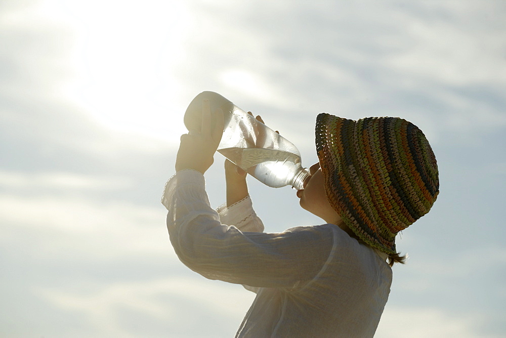 Girl drinking a bottle of water, Travemuende Bay, Schleswig-Holstein, Germany