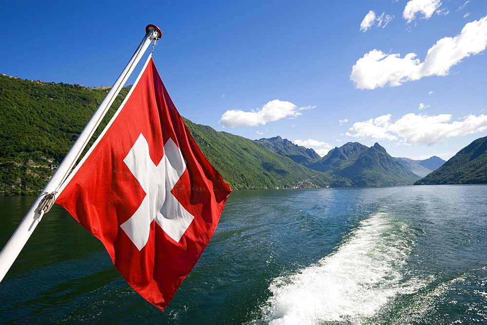 Motorboat with Swiss Flag on Lake Lugano, Lugano, Ticino, Switzerland