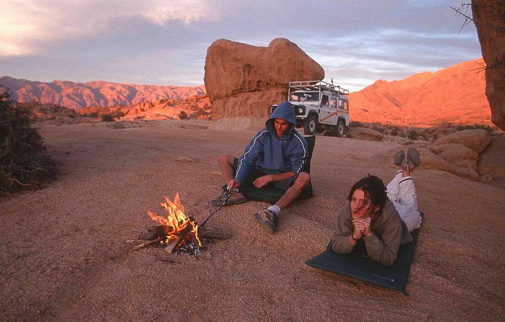 Couple at a bonfire, Tafraout, Morocco, Africa