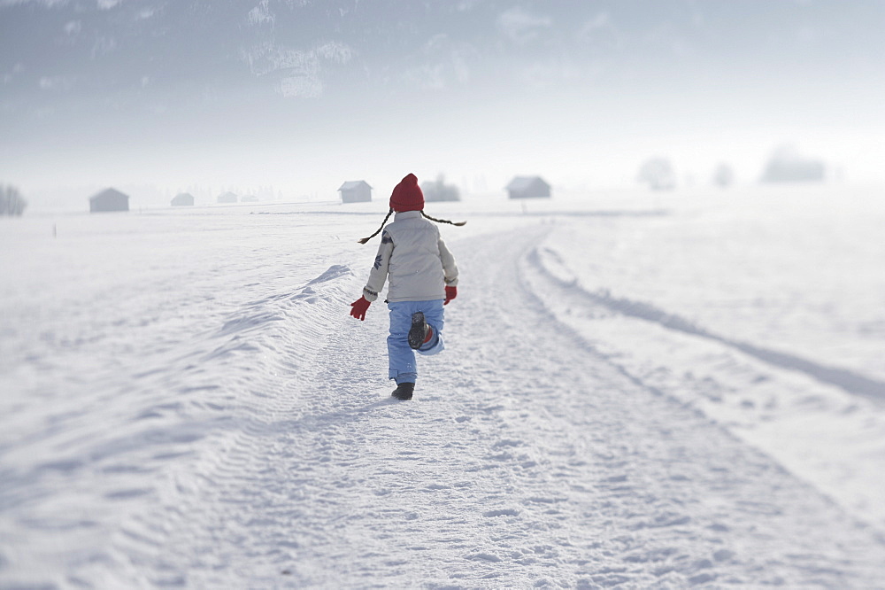 Girl 5-6 Years, running on snow, rearview