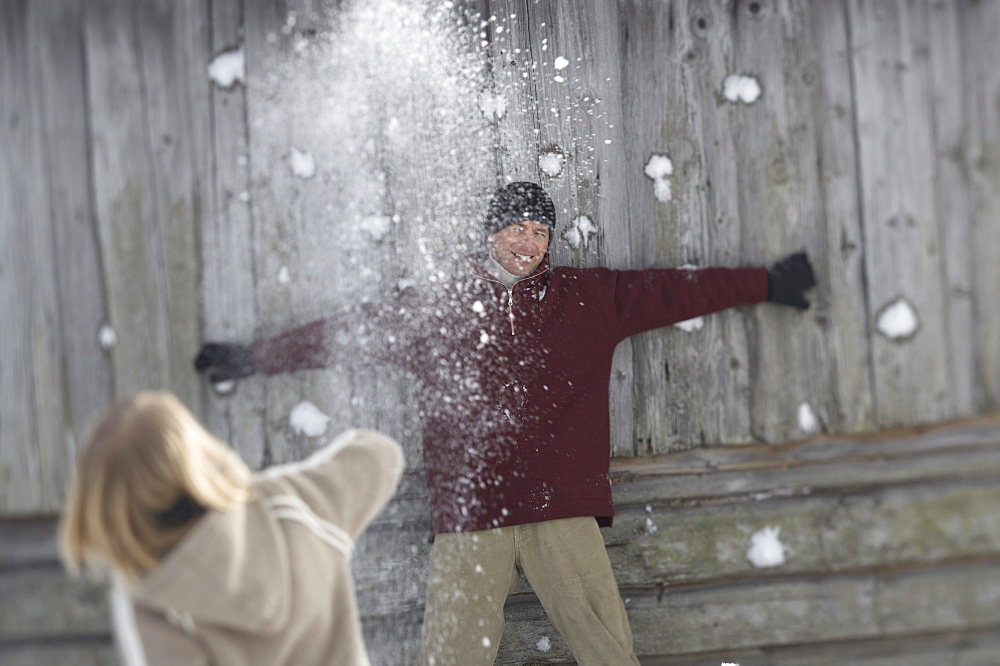 Family throwing snowballs