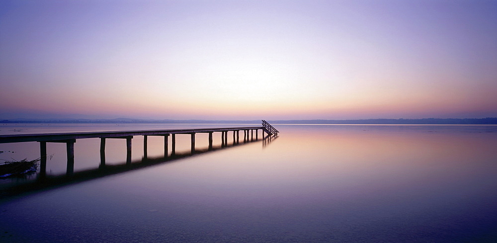 Wooden pier over body of water, St. Heinrich, Starnberger See, Upper Bavaria, Germany