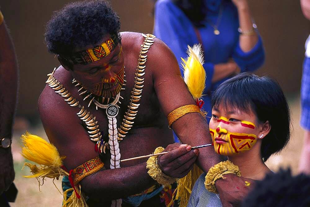 Aborigine painting the face of an Asian girl, Face paints, Royal Easter Show, Sydney, NSW, Australia