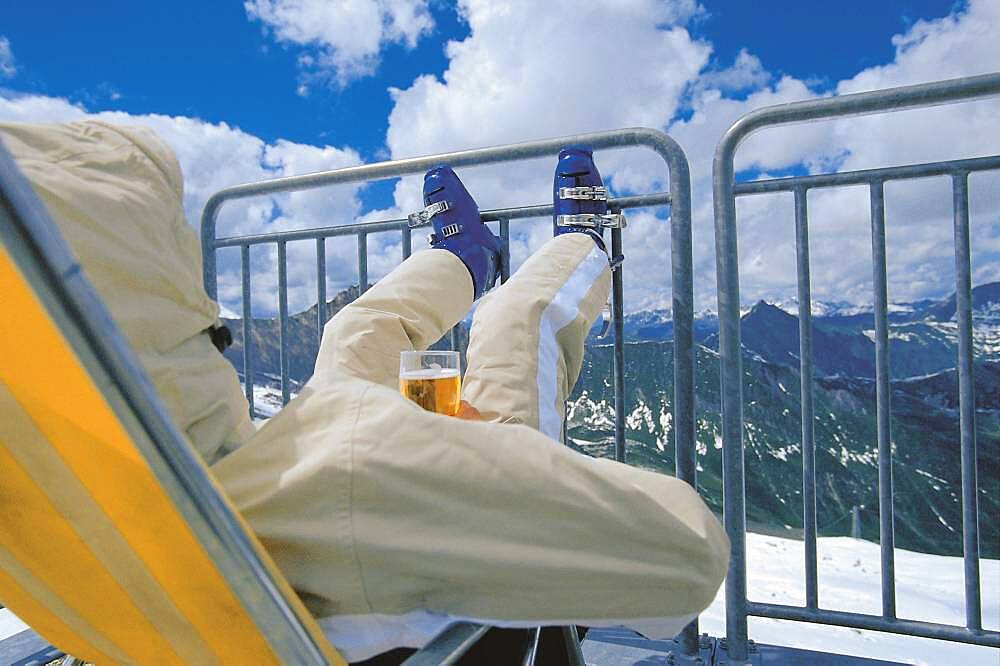 Skier relaxing and drinking beer