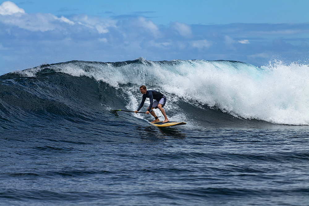 SUP stand up paddler on a breaking wave in the teahupoo surf area, Tahiti Iti, Tahiti, Windward Islands, French Polynesia, South Pacific