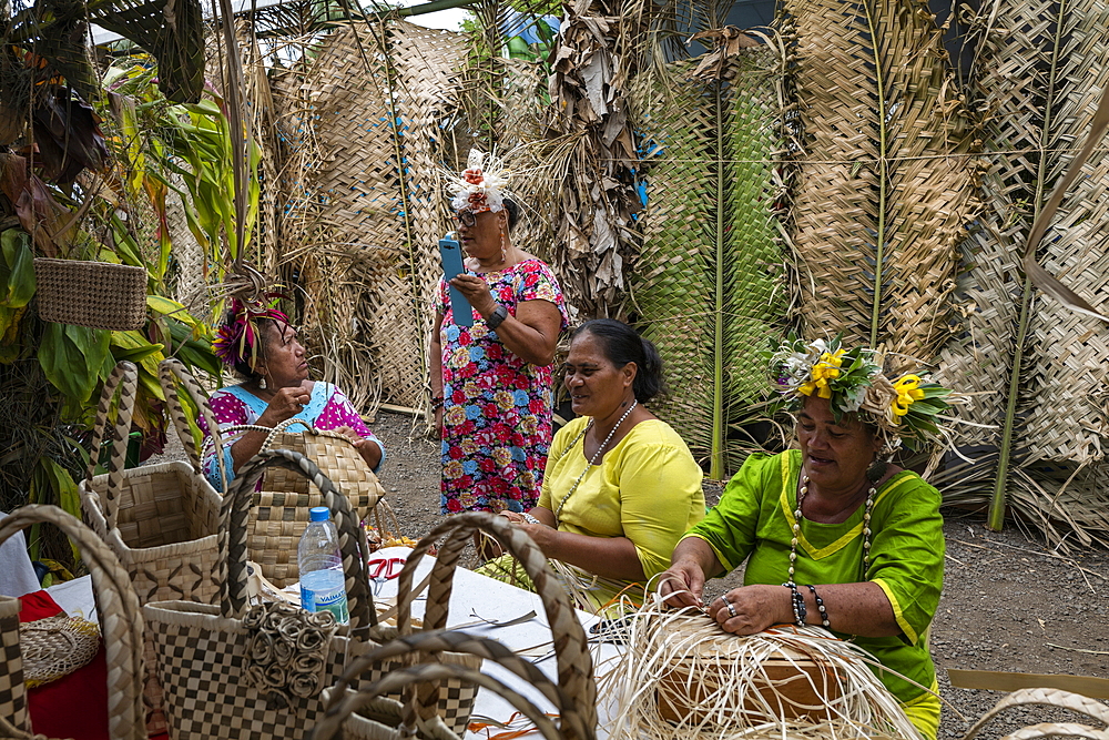 Women demonstrate traditional weaving at a cultural festival, Papeete, Tahiti, Windward Islands, French Polynesia, South Pacific