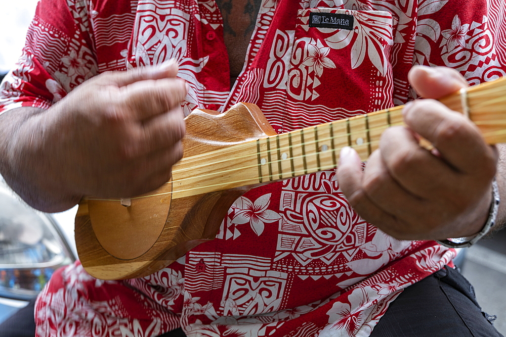 Tahitian man plays ukulele guitar at a cultural festival, Papeete, Tahiti, Windward Islands, French Polynesia, South Pacific