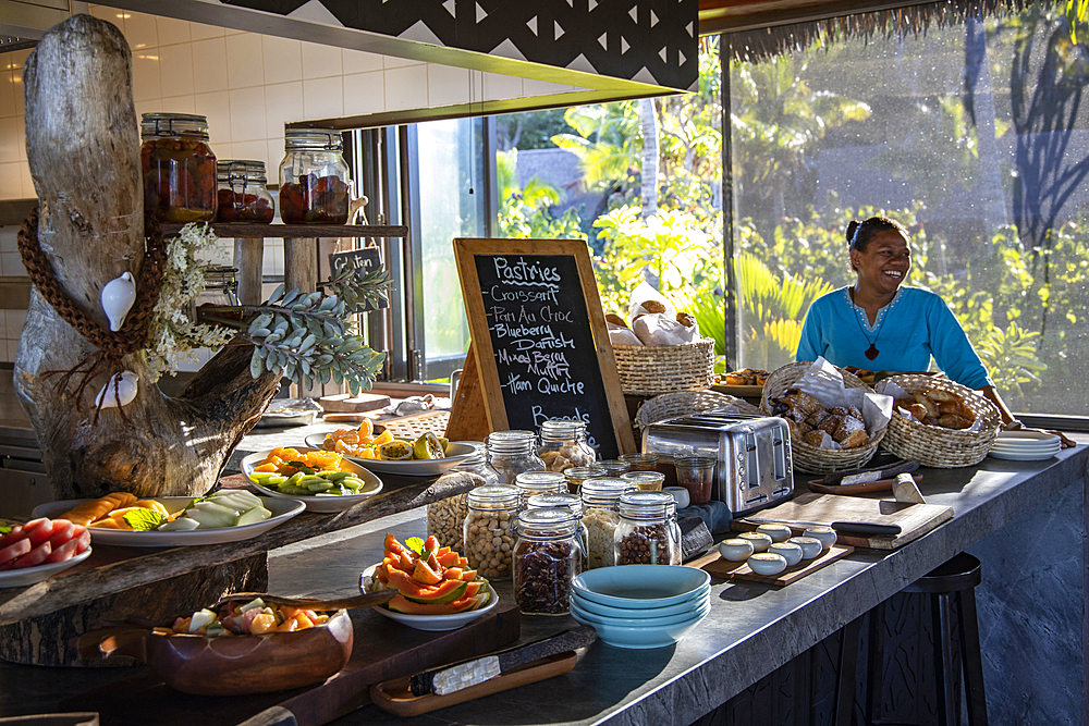 Smiling waitress behind a fantastic breakfast buffet in the Tovolea Restaurant of the Six Senses Fiji Resort, Malolo Island, Mamanuca Group, Fiji Islands, South Pacific