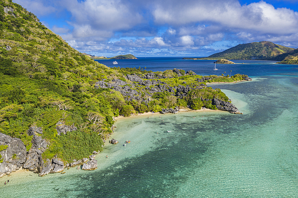 Aerial view from side of Sawa-i-Lau Mountain with the cruise ship MV Reef Endeavor (Captain Cook Cruises Fiji) in the distance, Sawa-i-Lau Island, Yasawa Group, Fiji Islands, South Pacific