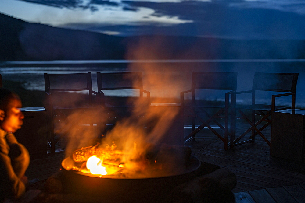 Campfire in fireplace in the luxury tented resort Magashi Camp (Wilderness Safaris) on the edge of Rwanyakazinga Lake in Akagera National Park, Eastern Province, Rwanda, Africa