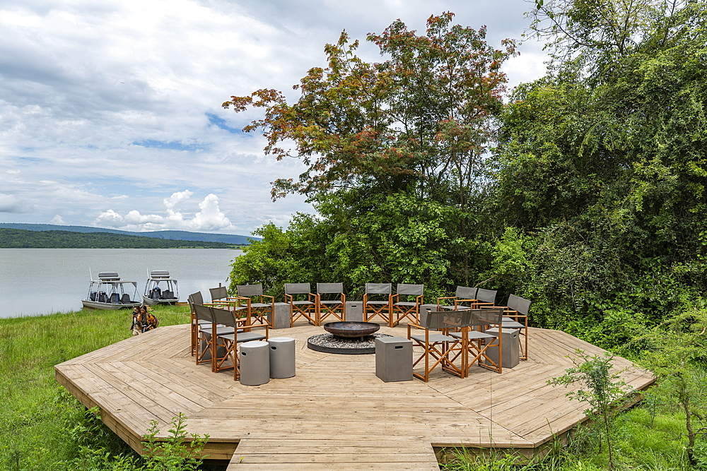 Chairs surround fire pit at the luxury tented resort Magashi Camp (Wilderness Safaris) on the banks of Rwanyakazinga Lake, Akagera National Park, Eastern Province, Rwanda, Africa