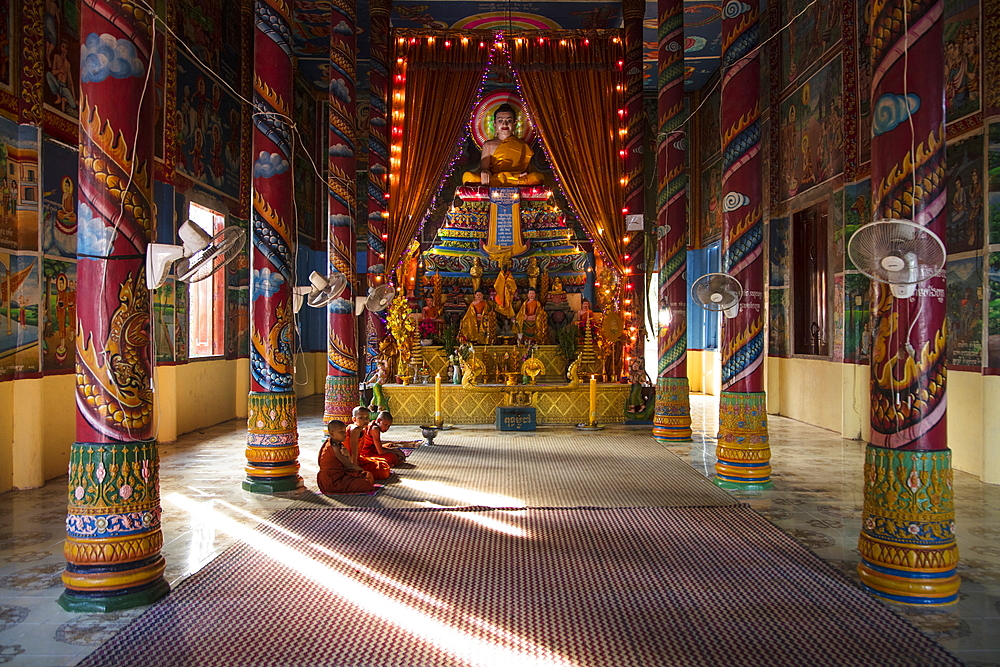 Young Buddhist monks sitting in front of the shrine in the temple, Preah Prosop, Mekong River, Kandal, Cambodia, Asia