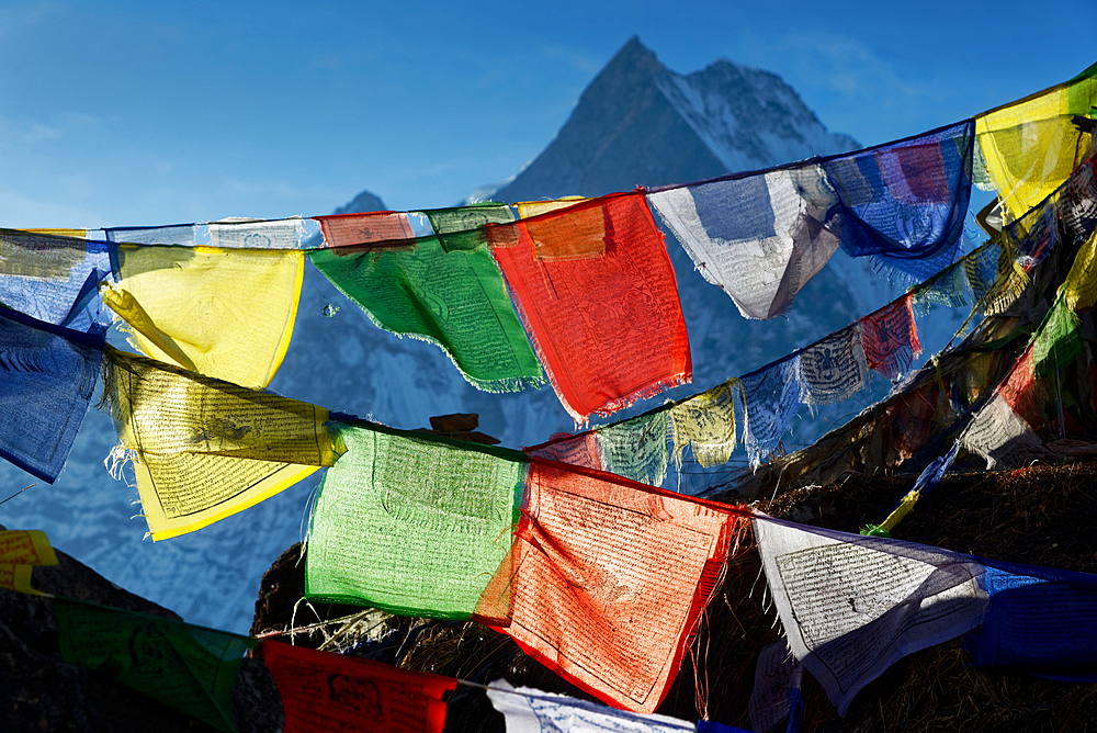 Buddhist prayer flags above Annapurna Base Camp, Nepal, Himalayas, Asia.