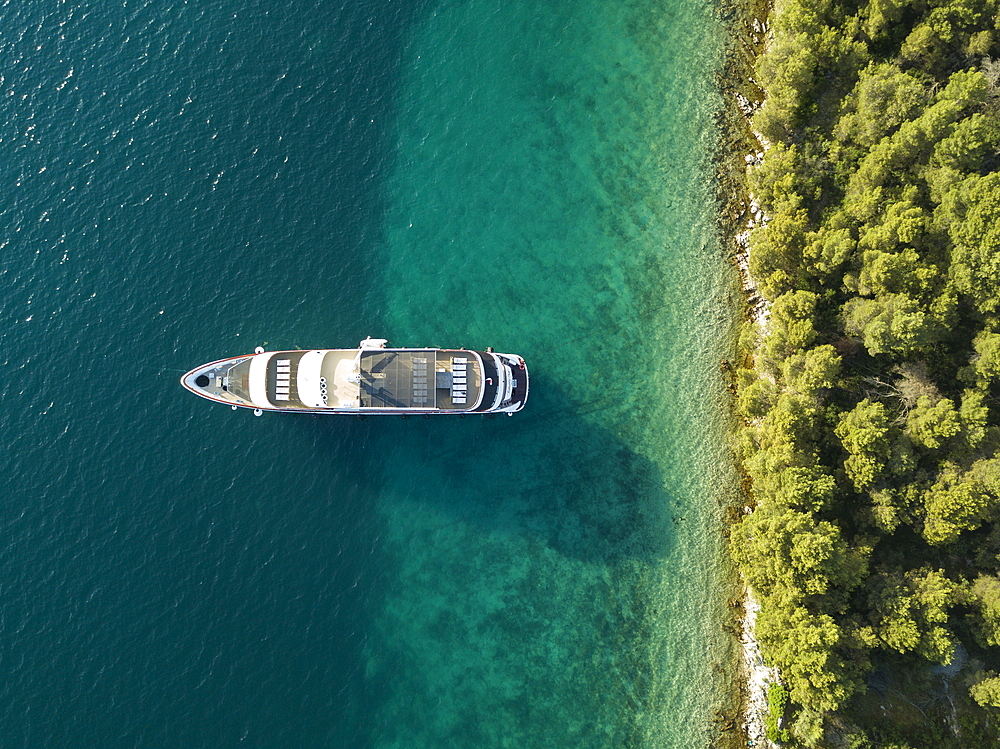 Aerial view of cruise ship in pristine bay at a swim stop for passengers, near Kukljica, Zadar, Croatia, Europe