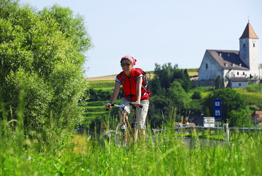 Female cyclist, St. Nicholas' Church, Danube Cycle Route Passau Vienna, Lower Austria, Austria