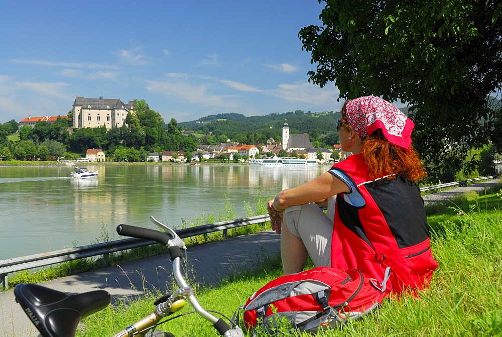 Woman looking over river Danube to Grein, Upper Austria, Austria