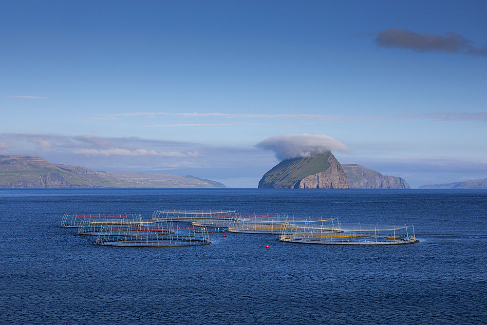 Fish farm off Koltur Island in the sun, Faroe Islands