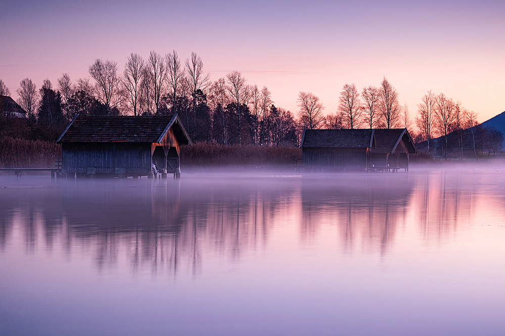 View of the wooden huts in Kochelsee, Schlehdorf at sunrise, Bavaria, Germany, Europe