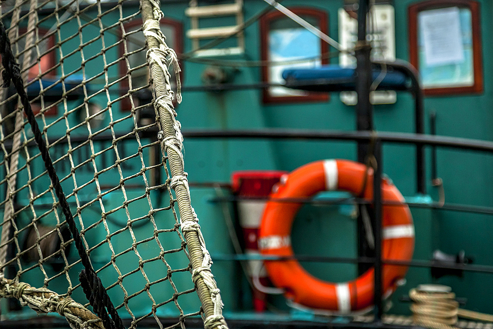 Net and lifebuoy on a fishing boat in Groningen, the Netherlands